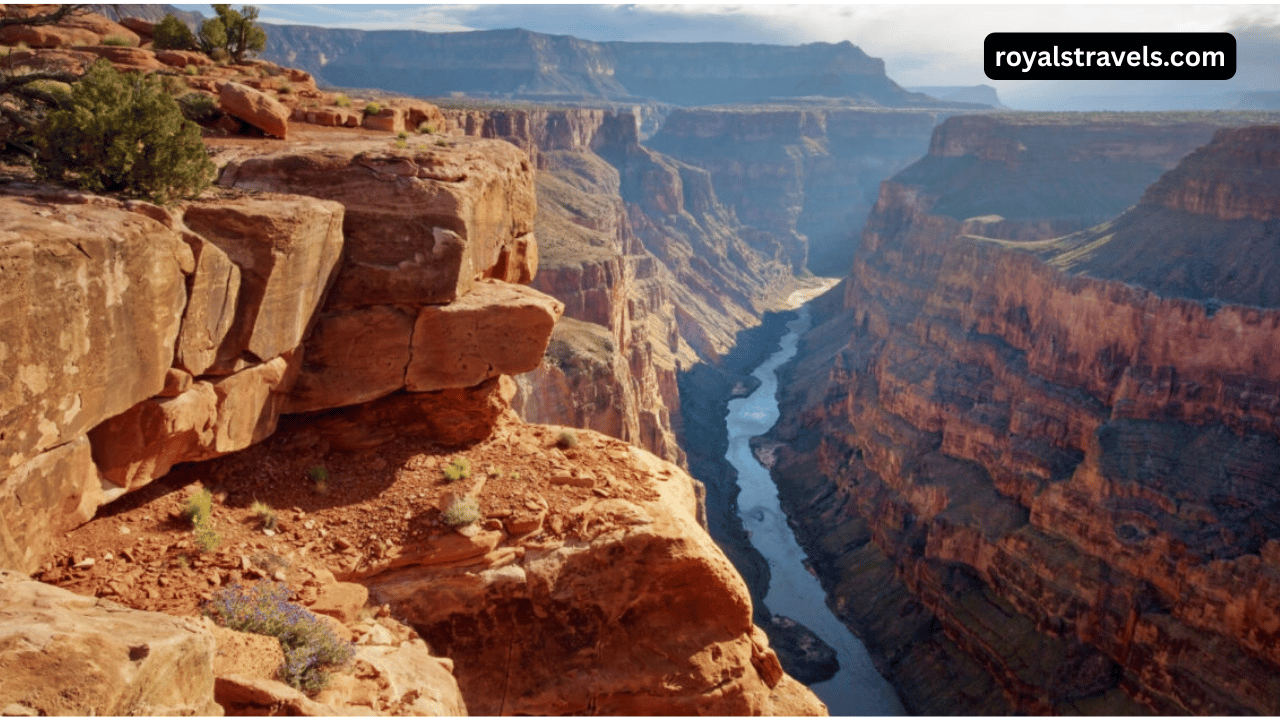 Panoramic view of the Grand Canyon at sunrise with layered red rock formations