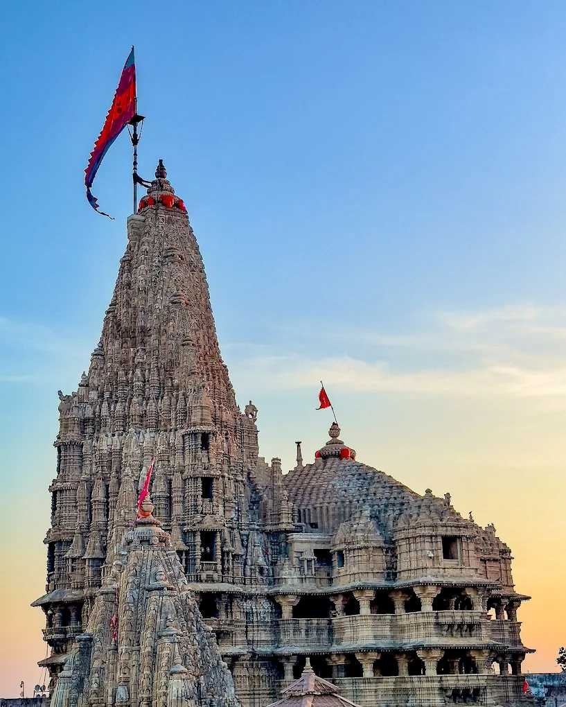 Dwarkadhish Temple shikhara with sacred flag flying against the evening sky in Dwarka, Gujarat