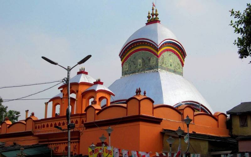 Kalighat Kali Temple exterior in Kolkata with traditional white dome and orange temple structure