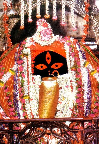 Sacred idol of Goddess Kali at Kalighat Temple Kolkata adorned with flowers and traditional decorations