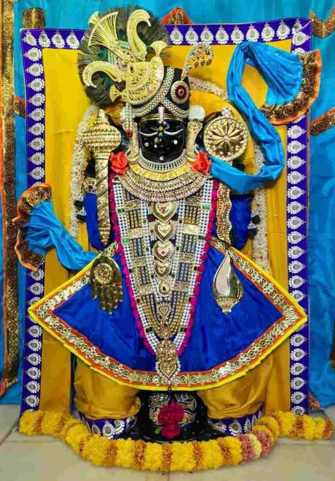 Dwarkadhish deity adorned with traditional jewelry and colorful silk garments inside Dwarka temple