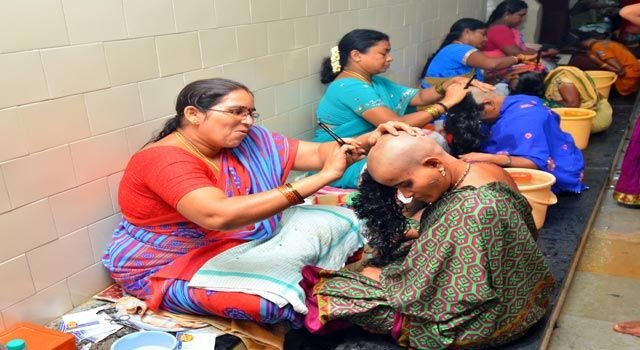 Female barbers performing tonsuring for women devotees at Tirumala Kalyanakatta as part of the sacred hair offering ritual to Lord Venkateswara.