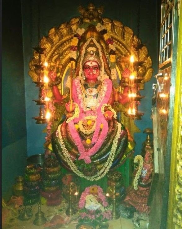 Sacred idol of Goddess Mariamman decorated with flowers and lamps inside Samayapuram Mariamman Temple