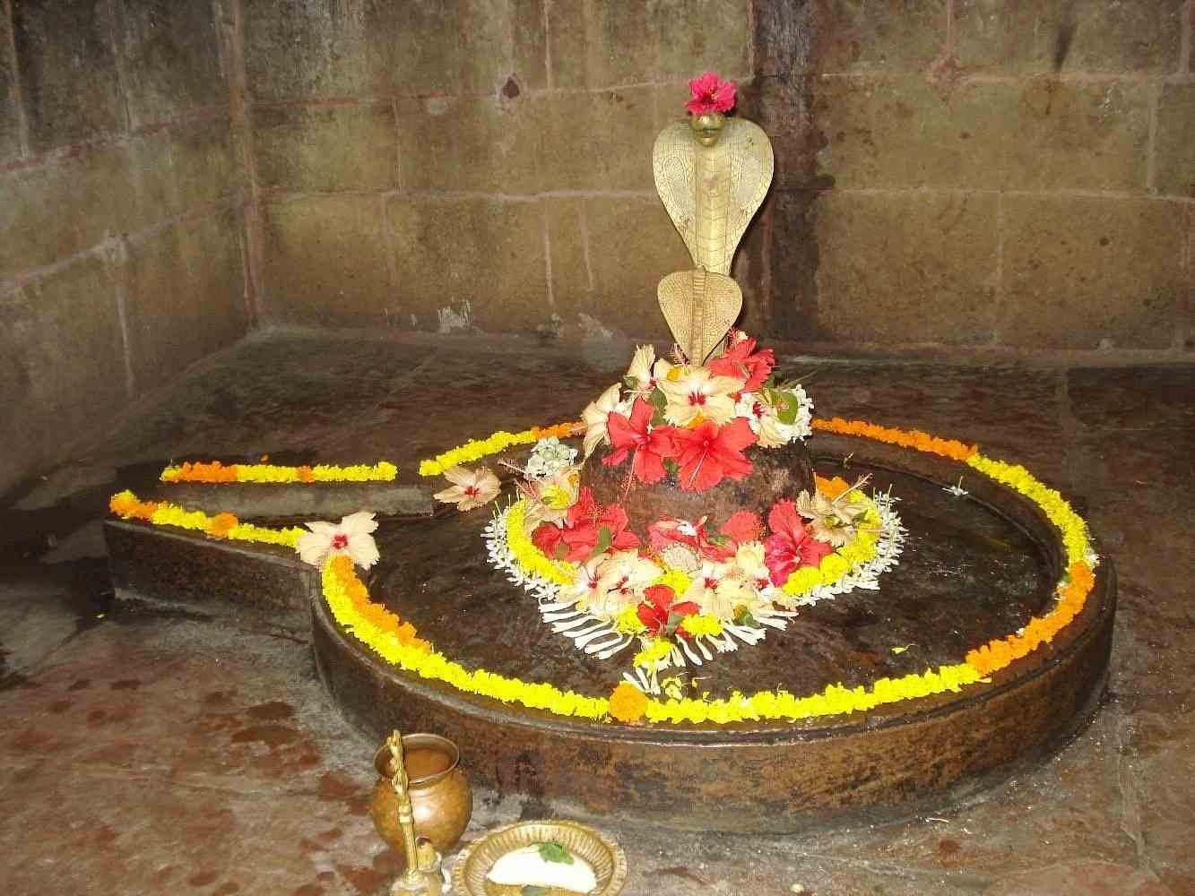 Sacred Shiva Lingam decorated with flowers inside Mukteswara Temple Bhubaneswar.