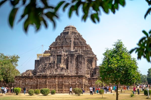 Wide view of Konark Sun Temple complex surrounded by greenery and visitors in Odisha.