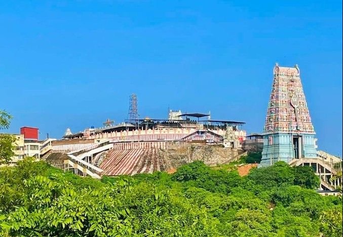 Panoramic hilltop view of Thiruttani Murugan Temple surrounded by greenery.