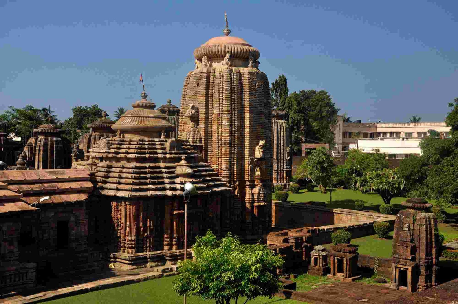 Exterior view of Lingaraj Temple Bhubaneswar surrounded by greenery and ancient temple structures