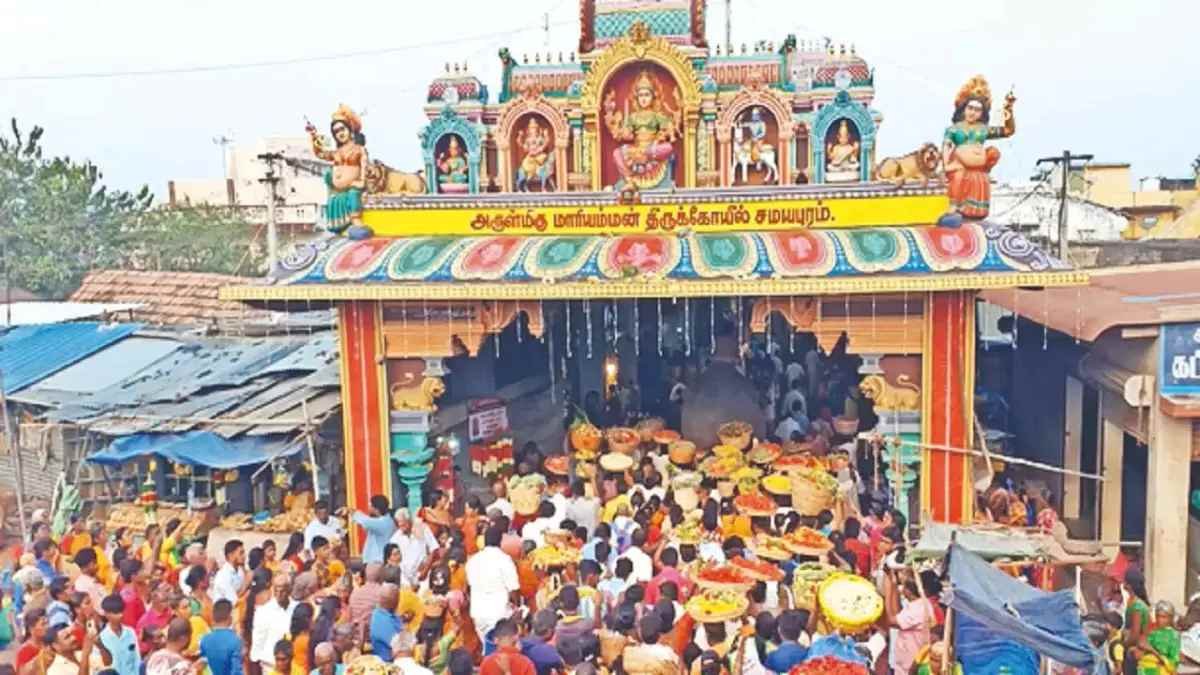 Devotees gathered at the entrance of Samayapuram Mariamman Temple during a festival celebration