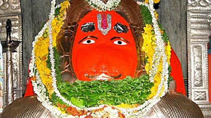 Sacred idol of Lord Hanuman at Karmanghat Hanuman Temple in Hyderabad decorated with flowers and traditional ornaments.