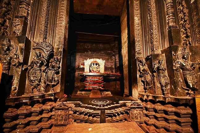 Entrance to the sanctum of Ramappa Temple featuring detailed stone carvings and the sacred Shiva Lingam.