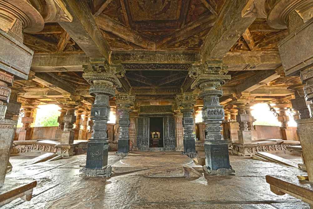 Spacious interior hall of Ramappa Temple with intricately carved stone pillars and ceiling architecture.