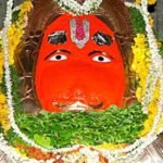 Sacred idol of Lord Hanuman at Karmanghat Hanuman Temple Hyderabad adorned with flowers, betel leaves, and traditional decorations.
