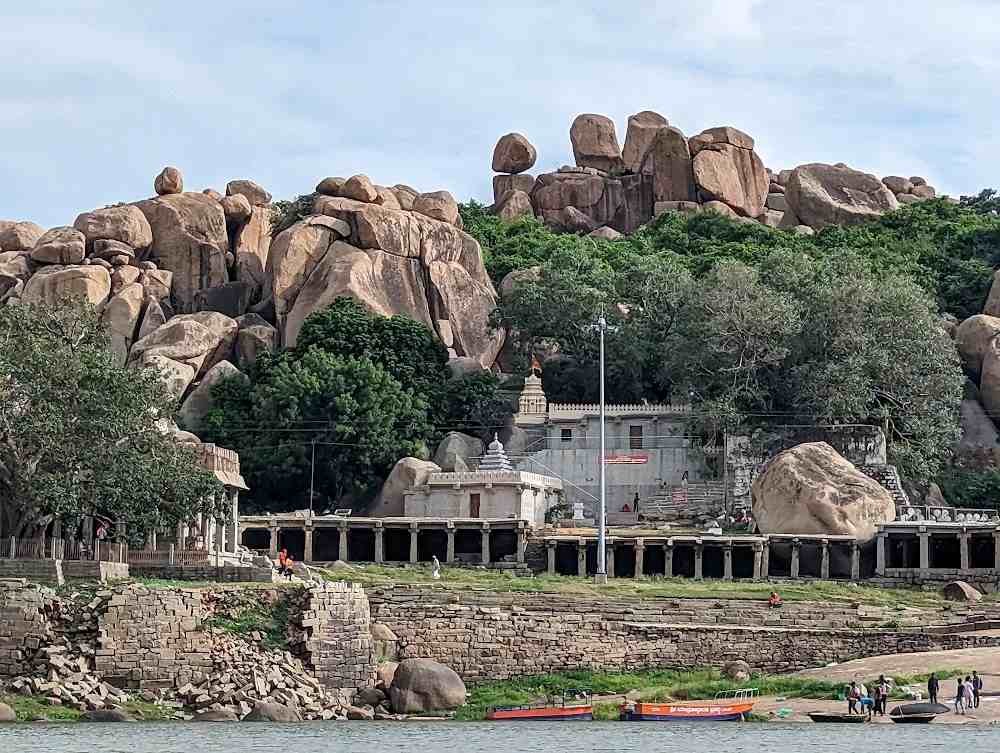 Yantrodharaka Hanuman Temple surrounded by Hampi's iconic granite boulders and the Tungabhadra River.